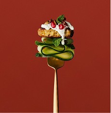 Burger with cucumber and toppings on a fork