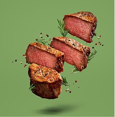 Pieces of grilled steak with herbs